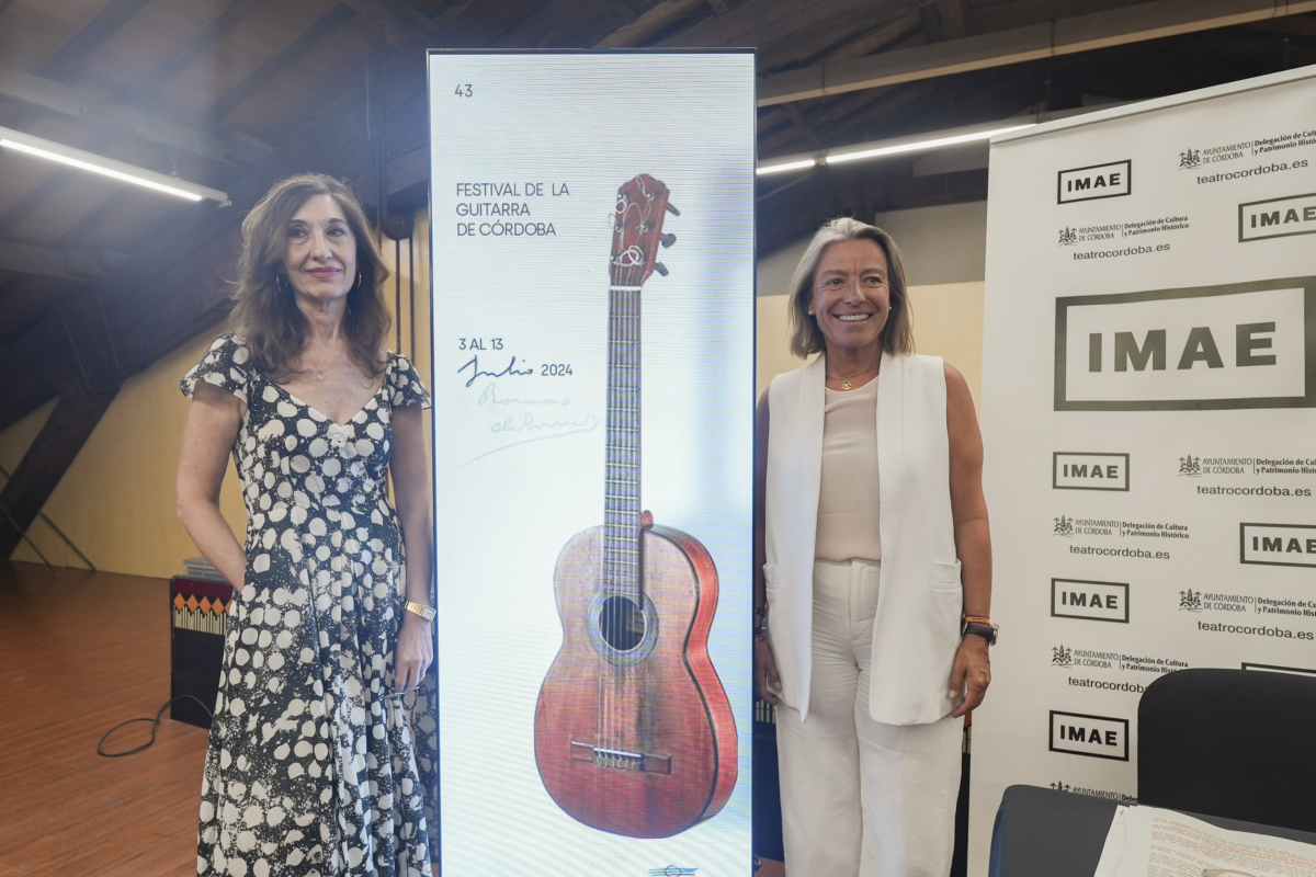 Dos mujeres se paran frente a un cartel que dice festival de la guitarra de córdoba. | 43 FESTIVAL DE LA GUITARRA DE CÓRDOBA IMAE 3 AL 13 Julio 2024 UNTAMENTO Delegación de Cultura teatrocordoba.es Delegación de Cal DE CORDOBA y Patrimonio Histó teatrocordoba.es IMAE IMAE IMAE AYUNTAMIENTO Delegación de Cultura DE CORDOBA y Partic teatrocordoba.es IMAE AUNTAMENTO Delegación de Cultura DE CORDOBA y Patrimonio Hi teatrocordob IMAE +AMINTAMENTO Dele AYUNTAMIENTO Delegación de Cul DE CORDOBA ly Patrimonio Hist teatrocordoba.es IMAE AYUNTAMIENTO Delegación de Ca DE CORDOBA y Patrimonio Hist teatrocordoba.es